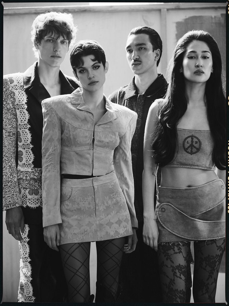 Four fashion models in a black and white studio shot wearing vintage-inspired outfits, with textured stockings and classic hairstyles.