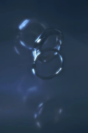 Silver metallic rings suspended and refracted in a deep blue atmospheric gradient with luminous highlights.