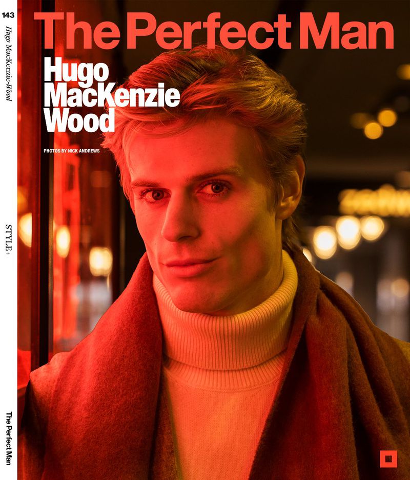 Magazine cover featuring a close-up of a fair-skinned adult man with blonde hair wearing a turtleneck and scarf, set against a blurred background.