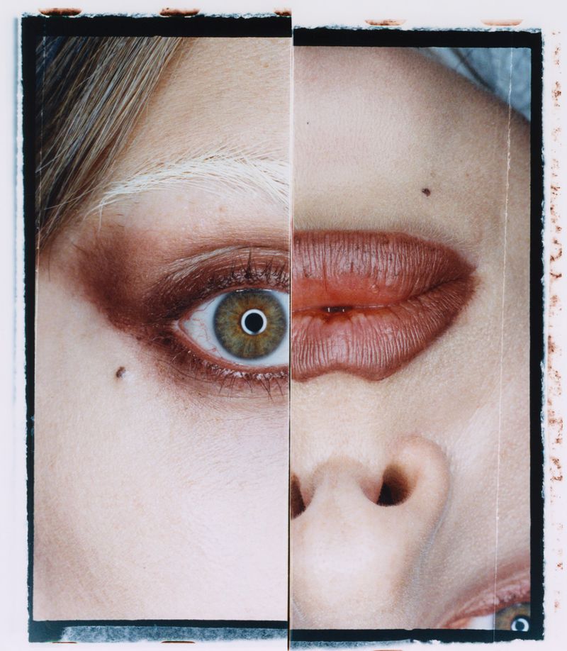 Dramatic beauty shot features a spliced face; eye, nose, and lips are centered in the frame, creating a striking and surreal portrait.