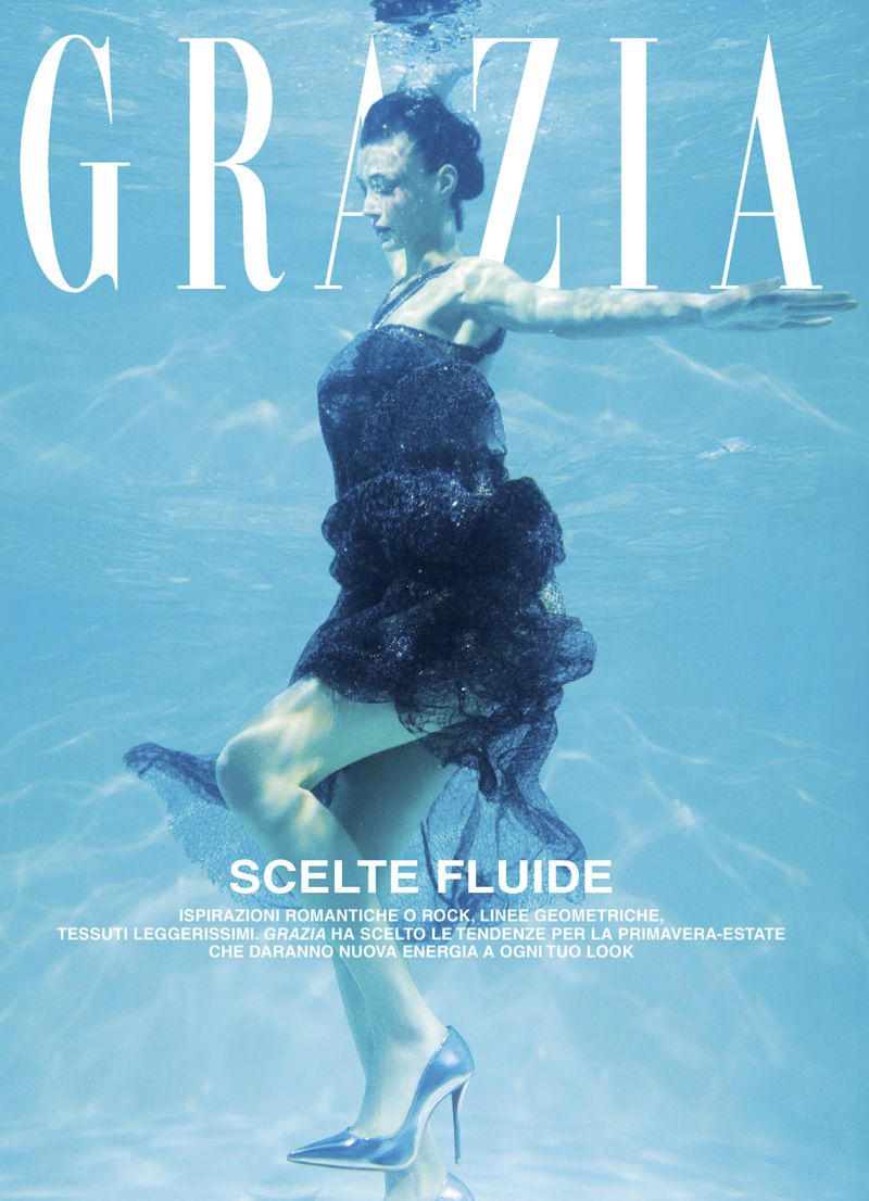 Fashion magazine cover featuring a woman in a black dress and silver heels, floating underwater with magazine text overlayed on top.