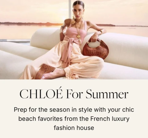 Model Titia Le Roux seated on a curved white sofa wearing a pink top and peach harem pants with a woven Chloe handbag.