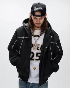 Man looking down wearing a black hooded jacket, white mesh athletic jersey, backwards Supreme cap, and large silver cross necklace.