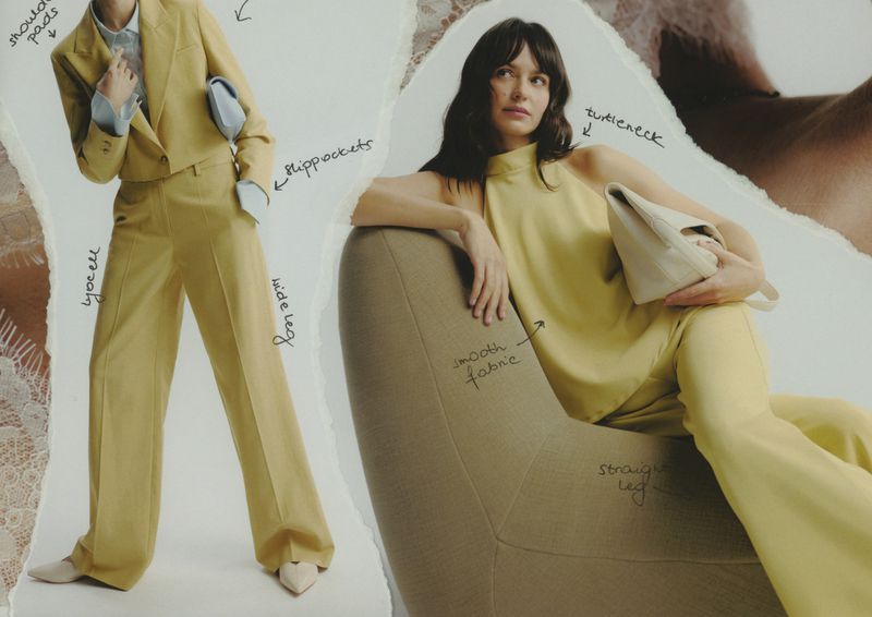 Two adult women pose wearing coordinating pale-yellow suits in a studio environment on a torn paper background for a fashion advertisement.