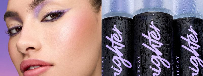 Close-up of a woman with violet eyeshadow, juxtaposed with black spray cans labeled 'Urban Decay,' suitable for beauty and fashion campaigns.