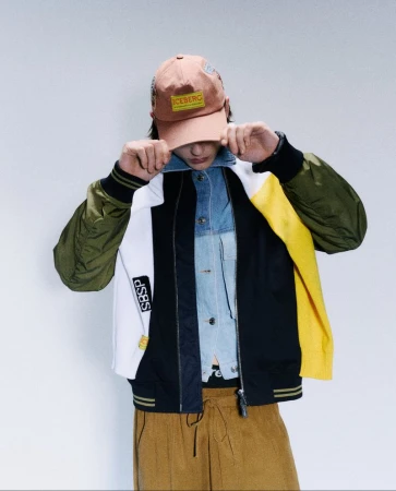 Model Etienne Maclaine in an Iceberg cap and colorblock jacket for the S/S 25 Mens Collection.