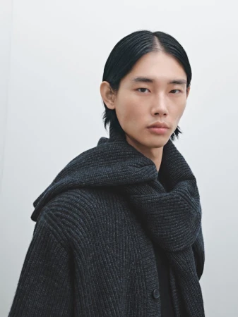 Taemin Park wearing a charcoal ribbed knit cardigan and matching scarf against a pale studio background for Massimo Dutti.