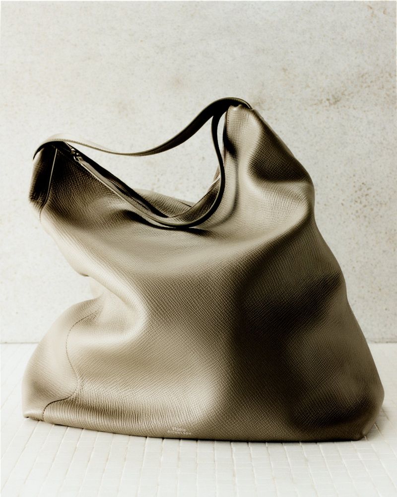 Studio shot of a leather hobo bag in a neutral setting, emphasizing its shape, texture, and design for fashion or editorial use.