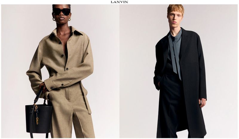 Two models showcase Lanvin Fall/Winter collection 2024: a woman in a beige set with a black handbag and a man in a black suit and overcoat.