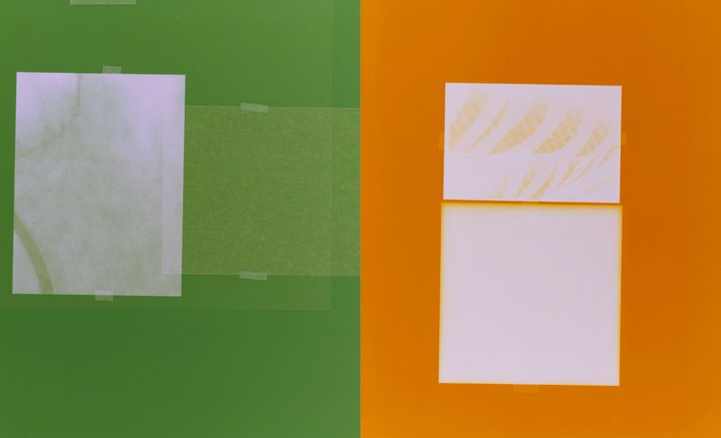 Abstract composition with two white cards, one featuring faint brown markings, affixed to green and orange backgrounds with clear tape.