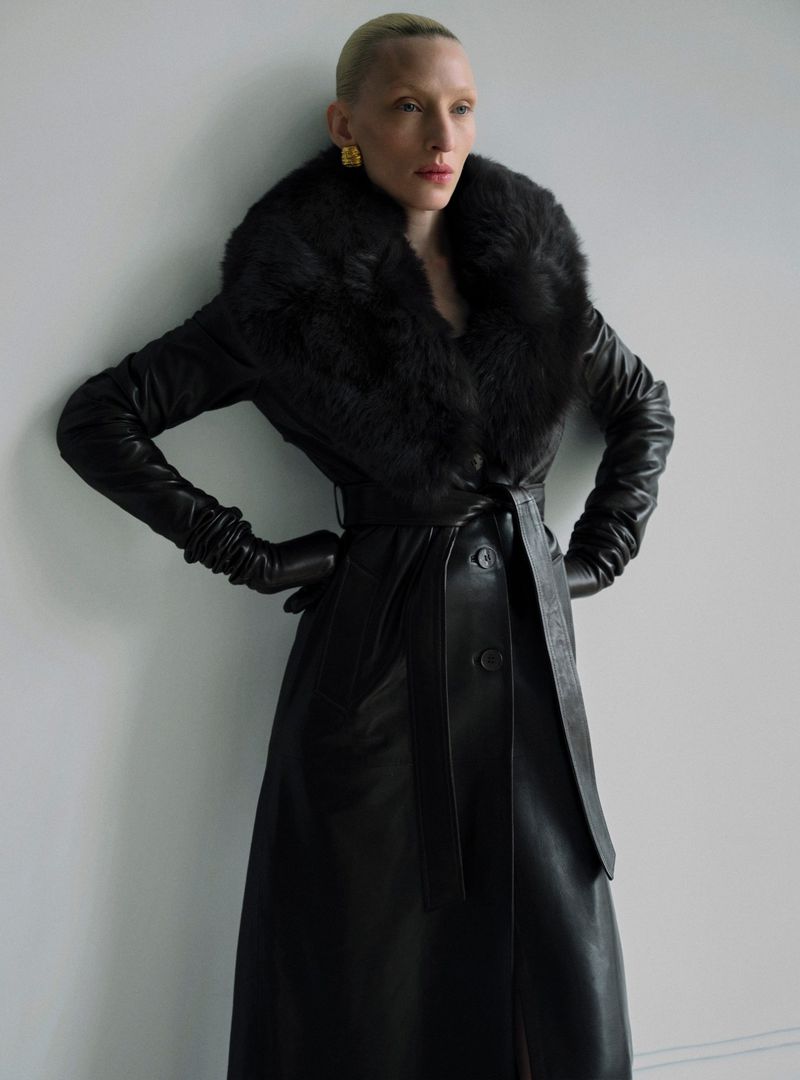 Model Maggie Maurer wearing a black leather coat with a furry collar for the Nour Hammour Fall 2024 campaign