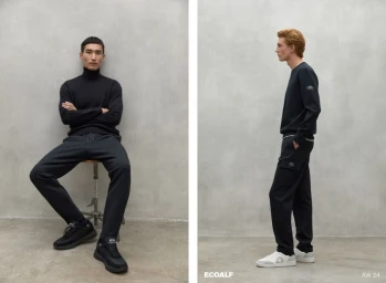 Two male models posing in black Ecoalf AW24 menswear against a grey textured studio wall in a side-by-side lookbook.