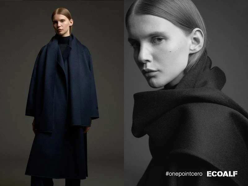 Monochrome fashion shot featuring a young woman in a navy overcoat, set against a subdued grey backdrop in a vertically split layout.
