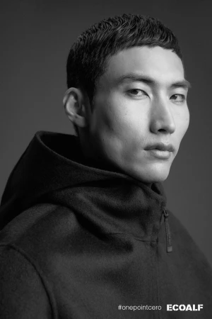Black and white portrait of model Do Byung Wook wearing a black hooded zip jacket for Ecoalf onepointcero.