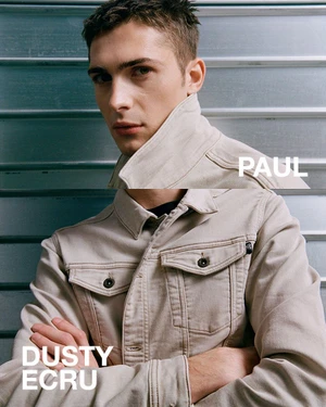 Model Paul Fontanier posing in a dusty ecru denim jacket in a split-frame portrait against a slatted metal background.