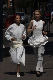 Two female models running outdoors on a sunny city street for Zara Woman AW24 campaign
