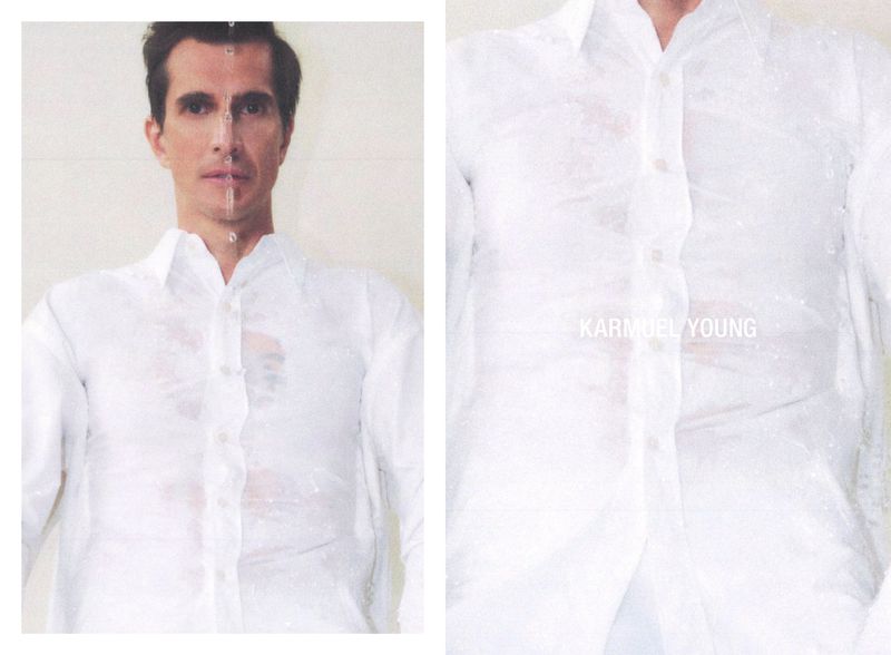 Portrait of an adult male wearing a wet white shirt. Studio lighting emphasizes the water droplets and fabric texture against a white backdrop.