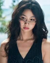 Portrait of Hoyeon Jung wearing wire-rimmed tinted glasses and a dark pinstripe vest outdoors.