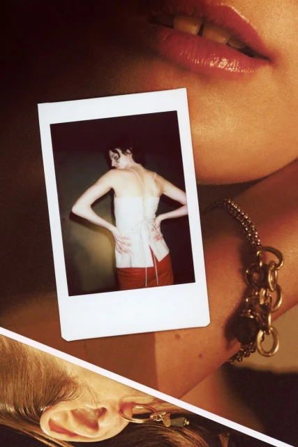 Close-up studio shot showcasing a woman in a Polaroid, featuring glossy lips, a chain bracelet, and a dangling earring.