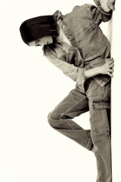 Model wearing a matching denim jacket and cargo pants posing against a seamless white studio background.