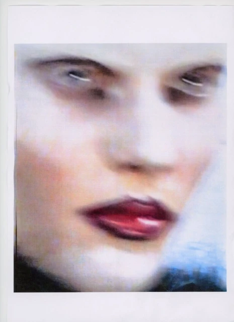 Painted close-up portrait of an adult female with fair skin, featuring red lipstick and light eye makeup, set against a blurred background.