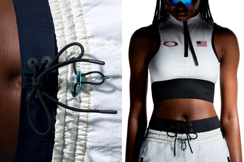 Woman in a studio wearing Oakley athletic wear, including a top with an American flag, standing against a white background.