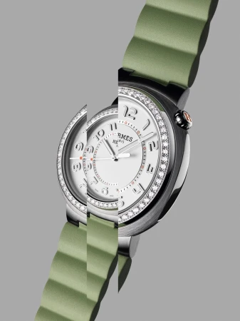 Elegant stainless steel and diamond-encrusted Hermès watch with a light green strap, presented against a sleek gray background.