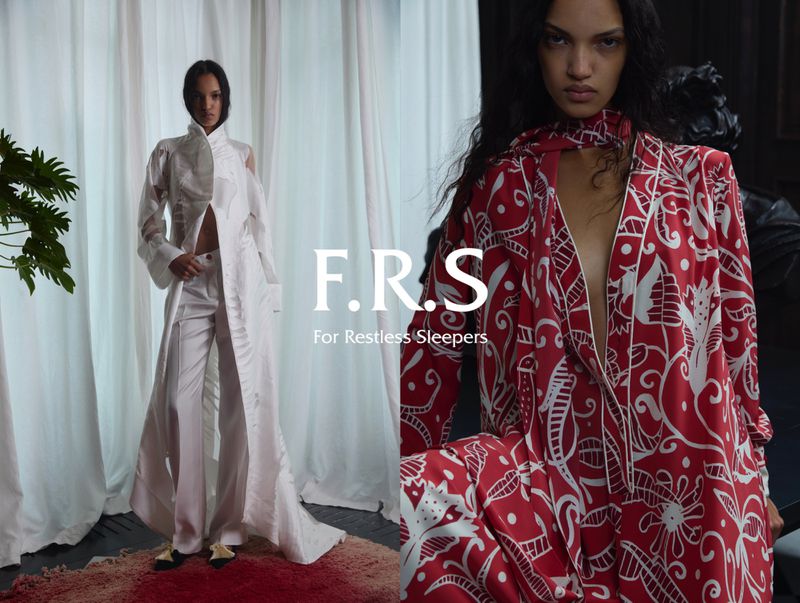 Fashion shot of two women wearing patterned lounge-wear in front of draped fabric, studio lighting, indoor setting, artistic design.
