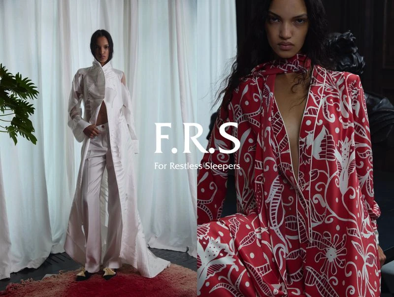 Fashion shot of two women wearing patterned lounge-wear in front of draped fabric, studio lighting, indoor setting, artistic design.