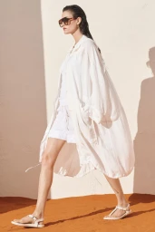 Model Vanessa Moody wearing an oversized white shirt and sunglasses in The White Edit campaign for Zara, photographed by Ned Rogers.