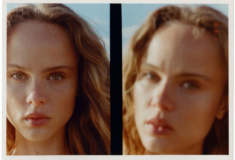 Close-up polaroid of a young adult woman with curly brown hair. Her facial expression is serious and directed at the camera in natural light.