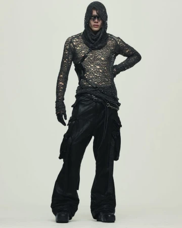 Fashion model poses in a distressed long-sleeve top, cowl, and wide-leg cargo pants in a studio. Full-length shot with neutral background.