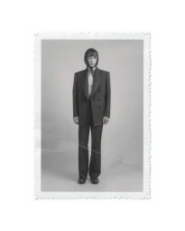 Model wearing a dark double-breasted suit and headscarf against a neutral backdrop in the MEYER S/S 25 lookbook.