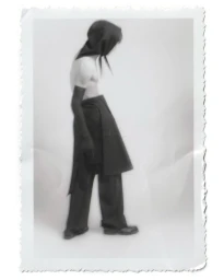 Model wearing dark hooded top and trousers with white background in MEYER lookbook