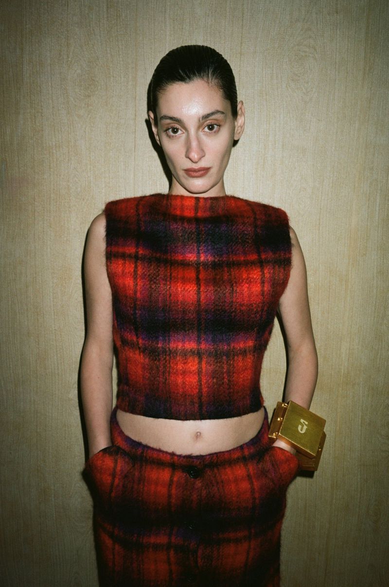 Model Salome Potskhverashvili wearing a red and black plaid cropped sleeveless top and gold cuff for Situationist.