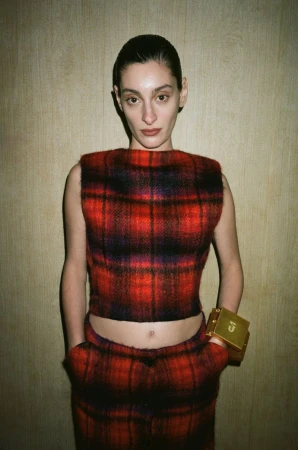 Model Salome Potskhverashvili wearing a red and black plaid cropped sleeveless top and gold cuff for Situationist.
