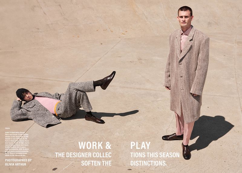 Two young adult men pose in a concrete skatepark. One lies down with an oversized jacket and beanie, the other stands in a coat and dress shoes.
