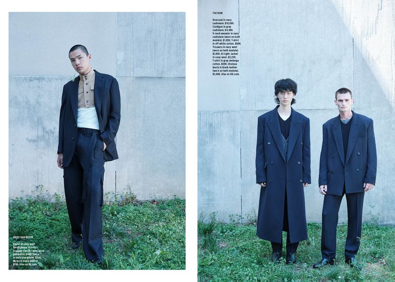 Fashion editorial featuring two men in blue wool suits standing in a field. One man stands in a black wool suit. 