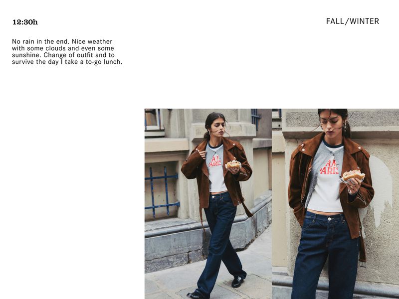 Fashion shot of a woman wearing a brown jacket and jeans, holding a sandwich, posed in an urban environment. Editorial lifestyle content.