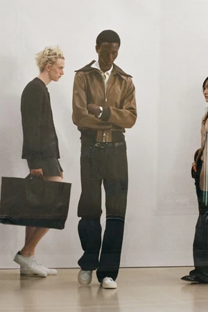 Three models wearing autumn apparel standing against a plain white studio background in a fashion lookbook image