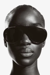 Close-up portrait of model Maty Fall wearing black sunglasses against a clean white background for H&M.
