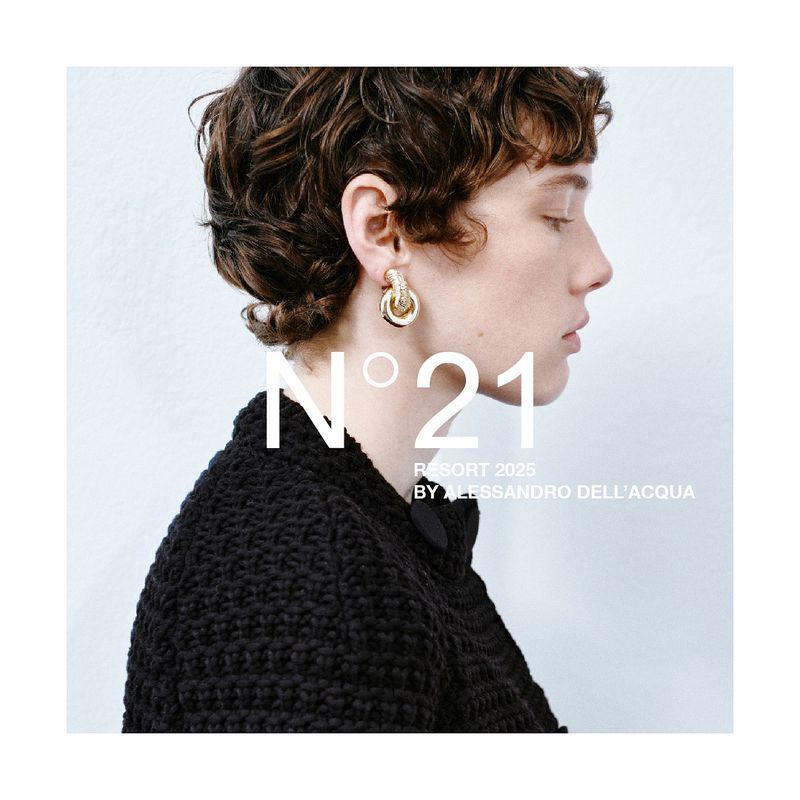 Profile of a woman with short brown hair and gold earrings. She is wearing a black textured jacket. White background with text overlay.