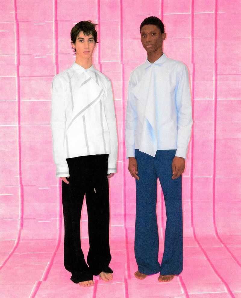 Two models in a studio setting, one wearing a white top and black pants, the other in a light blue shirt and dark blue pants, posing in front of a pink wall.