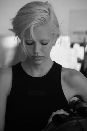 Delilah Belle looking downward in a black sleeveless tank top in black and white for Fear of God Summer 2024.