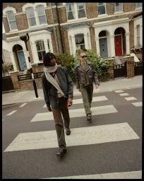 Two male models walking across a zebra crossing in a London street wearing casual apparel for Zara