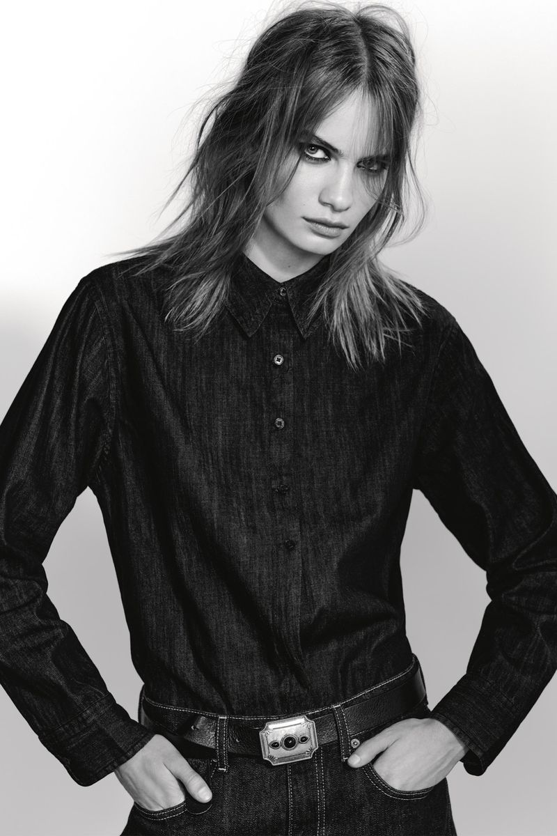 Model Nina Marker in a dark denim shirt and belt against a plain white studio background for Zara, photographed by Collier Schorr.