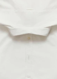 Detailed close-up view of a crisp white cotton button-down shirt collar and front button placket.