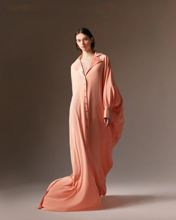 Model Lydia Waldrop wearing a floor-length peach draped gown for the Alexis Mabille Fall 2024 Couture lookbook.