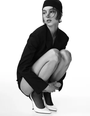 Model in black blazer and headband crouching in white slingback heels for Bershka project B&W by Javier Avila
