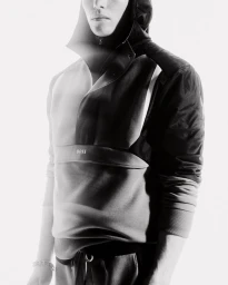 Model Rafael Mayers wearing a BOSS hooded colorblocked pullover against a pure white studio background.